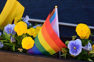 A pride flag and flowers